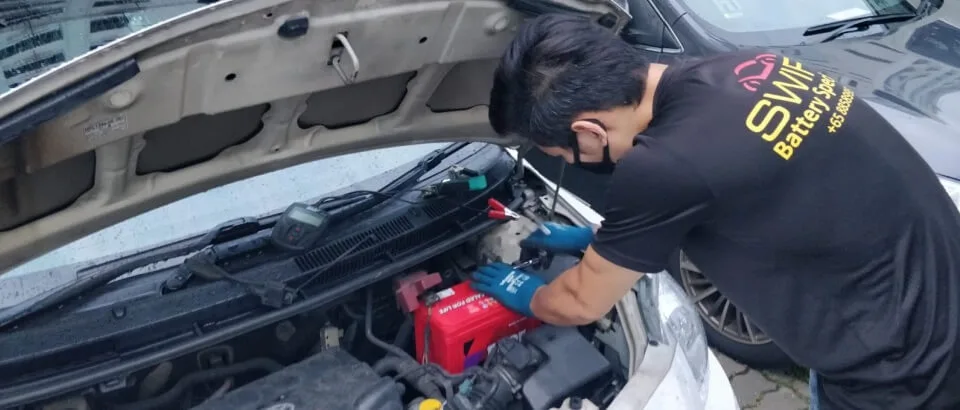 Mechanic Working on Car Battery