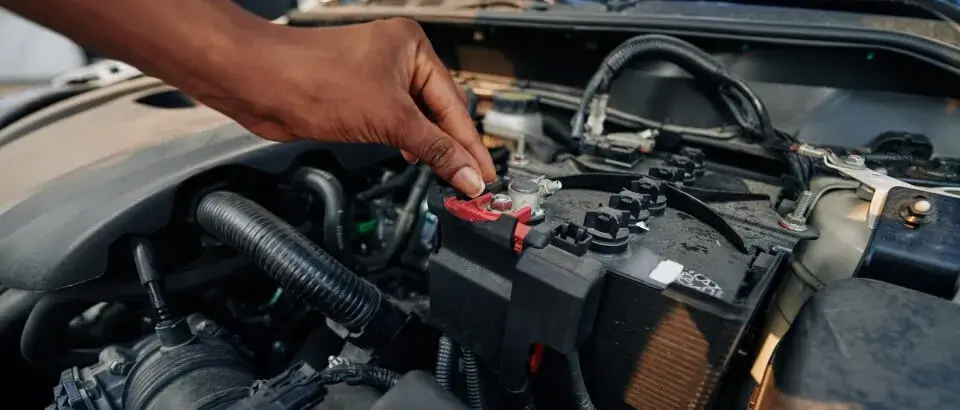 woman checking or changing car battery